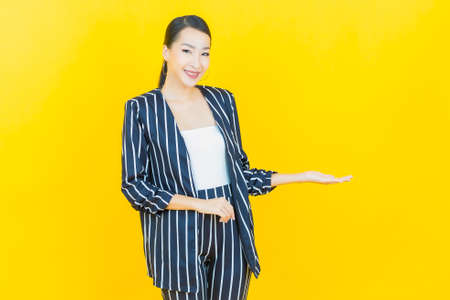 Portrait beautiful young asian woman smile with action on color backgroundの写真素材