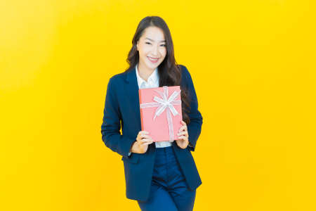 Portrait beautiful young asian woman smile with a lot of cash and money on color backgroundの写真素材