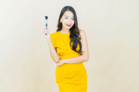Portrait beautiful young asian woman smile with action on color backgroundの写真素材