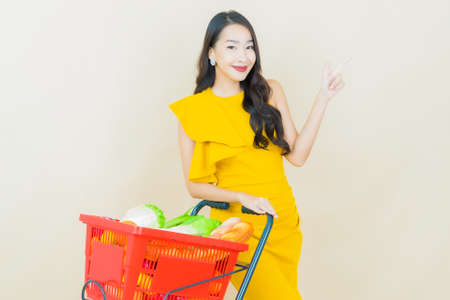Portrait beautiful young asian woman smile with action on color backgroundの写真素材