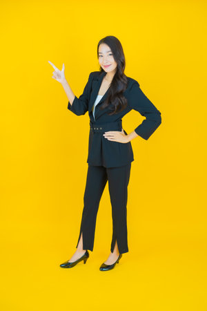 Portrait beautiful young asian woman smile with action on color backgroundの写真素材