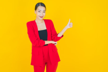 Portrait beautiful young asian woman smile with action on color backgroundの写真素材
