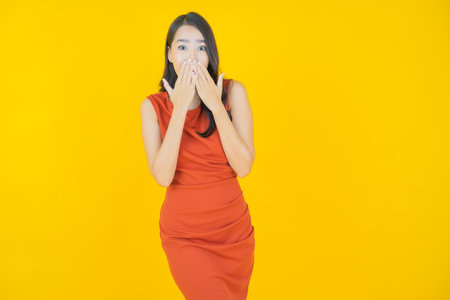 Portrait beautiful young asian woman smile with action on color backgroundの写真素材