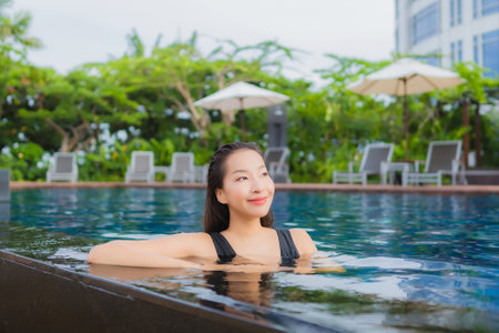 Portrait beautiful young asian woman leisure relax smile around outdoor swimming pool for vacationの写真素材