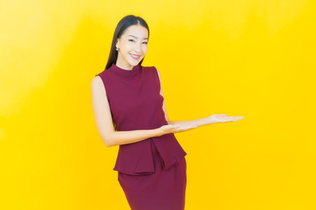 Portrait beautiful young asian woman smile with action on color backgroundの写真素材