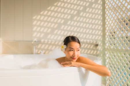Portrait young asian woman relax take a bath in bathtub for spa conceptの写真素材