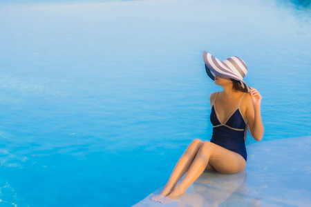 Portrait beautiful young asian woman relax around swimming pool in hotel resort for leisure in vacationの写真素材