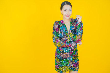 Portrait beautiful young asian woman smile with action on color backgroundの写真素材