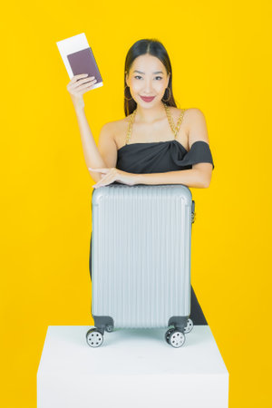 Portrait beautiful young asian woman with luggage bag and passport ready for travelの写真素材