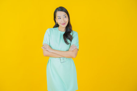 Portrait beautiful young asian woman smile with action on color backgroundの写真素材