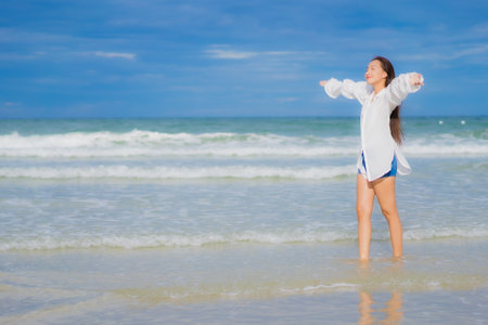 Portrait beautiful young asian woman relax smile around beach sea ocean in holiday vacation travel tripの写真素材
