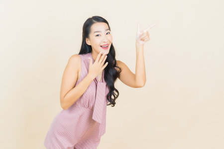 Portrait beautiful young asian woman smile with action on color backgroundの写真素材