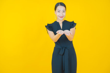 Portrait beautiful young asian woman smile with action on color backgroundの写真素材