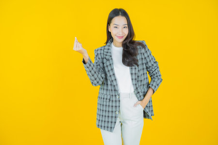 Portrait beautiful young asian woman smile with action on color backgroundの写真素材