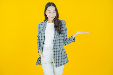 Portrait beautiful young asian woman smile with action on color backgroundの写真素材