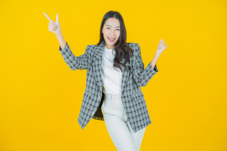 Portrait beautiful young asian woman smile with action on color backgroundの写真素材