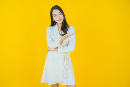 Portrait beautiful young asian woman smile with action on color backgroundの写真素材