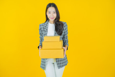 Portrait beautiful young asian woman with box ready for shipping on color background