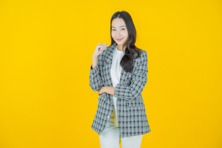 Portrait beautiful young asian woman smile with action on color backgroundの写真素材