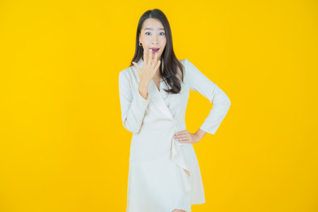 Portrait beautiful young asian woman smile with action on color backgroundの写真素材