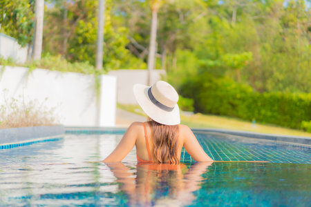 Portrait beautiful young asian woman relax smile leisure around outdoor swimming pool in hotel...