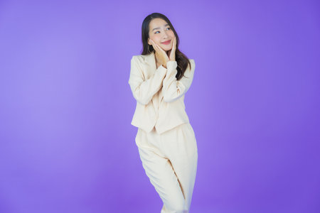 Portrait beautiful young asian woman smile with action on color backgroundの写真素材