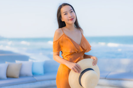 Portrait beautiful young asian woman happy smile around sea ocean beach and blue sky for leisure travel vacationの写真素材