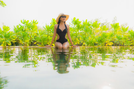 Portrait beautiful young asian woman   relax in swimming pool at hotel resort for leisure vacation...