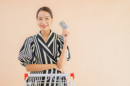 Portrait beautiful young asian woman with shopping cart for shopping groceryの写真素材
