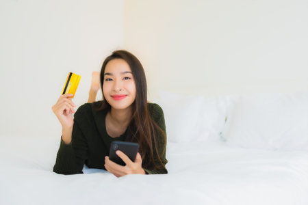 Portrait beautiful young asian woman with smart mobile phone and credit card for online shopping...
