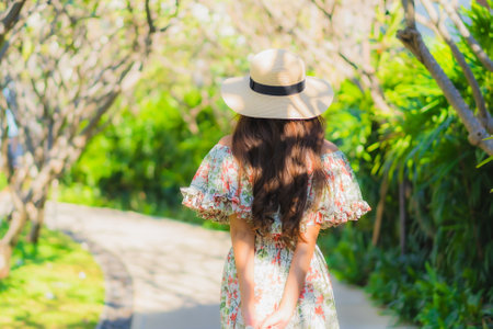 Portrait beautiful young asian woman walking with happy enjoy around outdoor garden viewの写真素材
