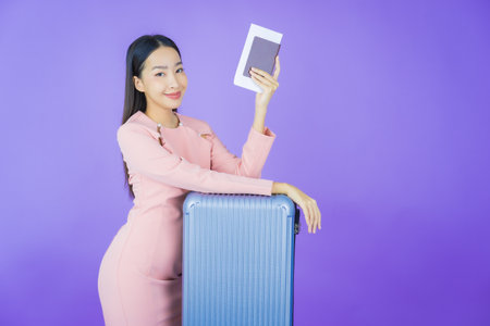 Portrait beautiful young asian woman with luggage bag and passport ready for travelの写真素材