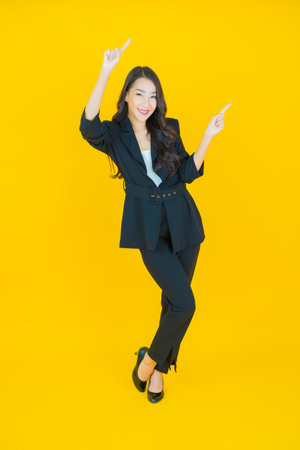 Portrait beautiful young asian woman smile with action on color backgroundの写真素材