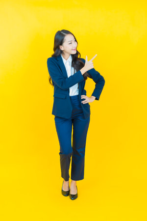 Portrait beautiful young asian woman smile with action on color backgroundの写真素材