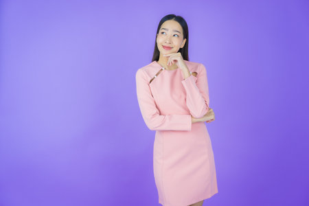 Portrait beautiful young asian woman smile with action on color backgroundの写真素材