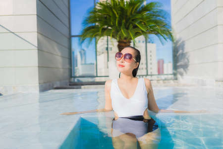 Portrait beautiful young asian woman relax happy smile leisure around outdoor swimming pool with...