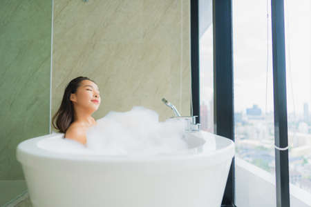 Portrait beautiful young asian woman relax and leisure in bathtub decoration in bathroom interior