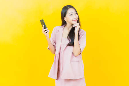 Portrait beautiful young asian woman smile with action on color backgroundの写真素材