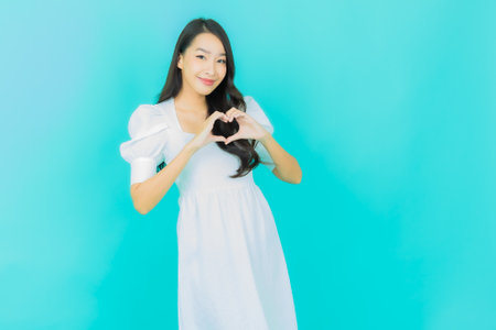 Portrait beautiful young asian woman smile with action on color backgroundの写真素材