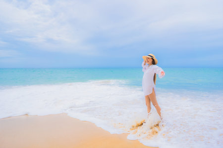 Portrait beautiful young asian woman relax leisure smile around beach sea ocean in travel vacationの写真素材