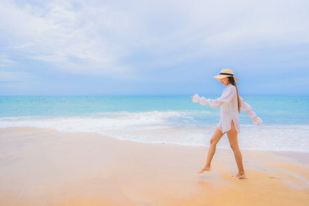 Portrait beautiful young asian woman relax leisure smile around beach sea ocean in travel vacationの写真素材