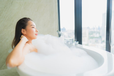 Portrait beautiful young asian woman relax and leisure in bathtub decoration in bathroom interiorの写真素材
