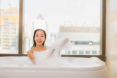 Portrait beautiful young asian woman relax enjoy take a bath at bathtub in bathroom interiorの写真素材