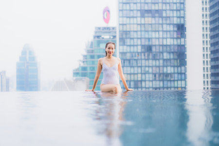 Portrait beautiful young asian woman relax smile leisure around outdoor swimming pool in hotel resortの写真素材