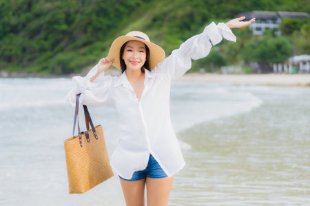 Portrait beautiful young asian woman relax smile around beach sea ocean in holiday vacation travel tripの写真素材