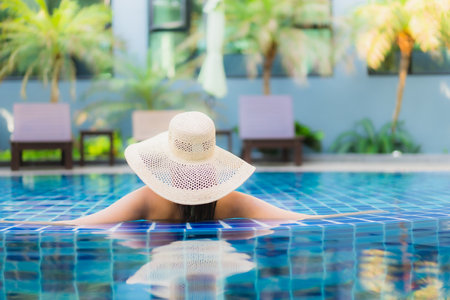 Portrait beautiful young asian woman relax around swimming pool in hotel resort for leisure in vacationの写真素材