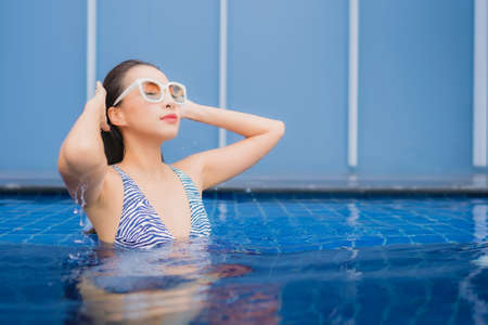 Portrait beautiful young asian woman relax leisure enjoy around outdoor swimming pool in vacationの写真素材