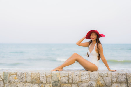 Portrait young asian woman happy smile relax around beach sea ocean for travel vacationの写真素材