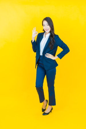 Portrait beautiful young asian woman smile with action on color backgroundの写真素材