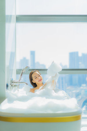 Portrait beautiful young asian woman relax smile enjoy in bathtub at bathroom interior